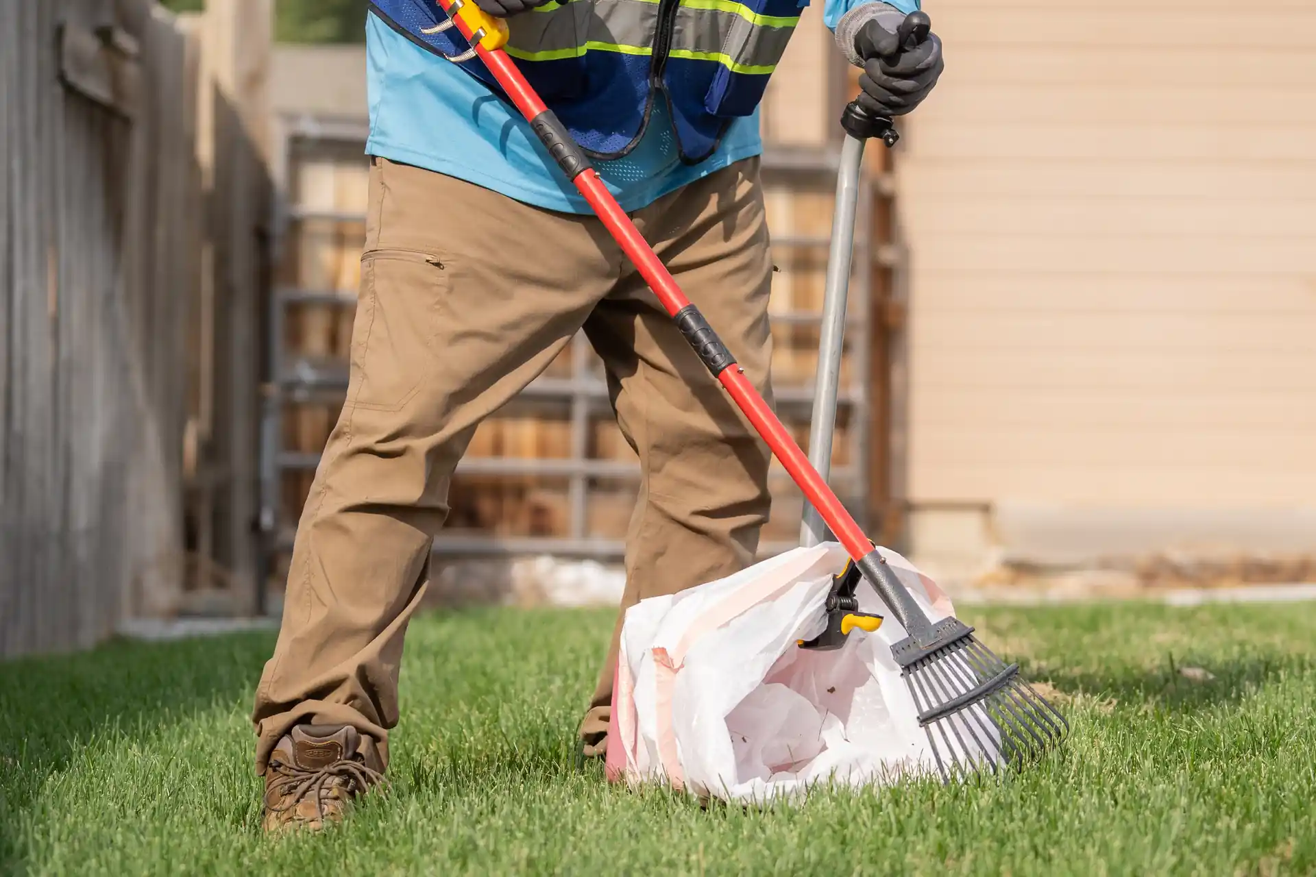Poop scooper service picking up dog poop.